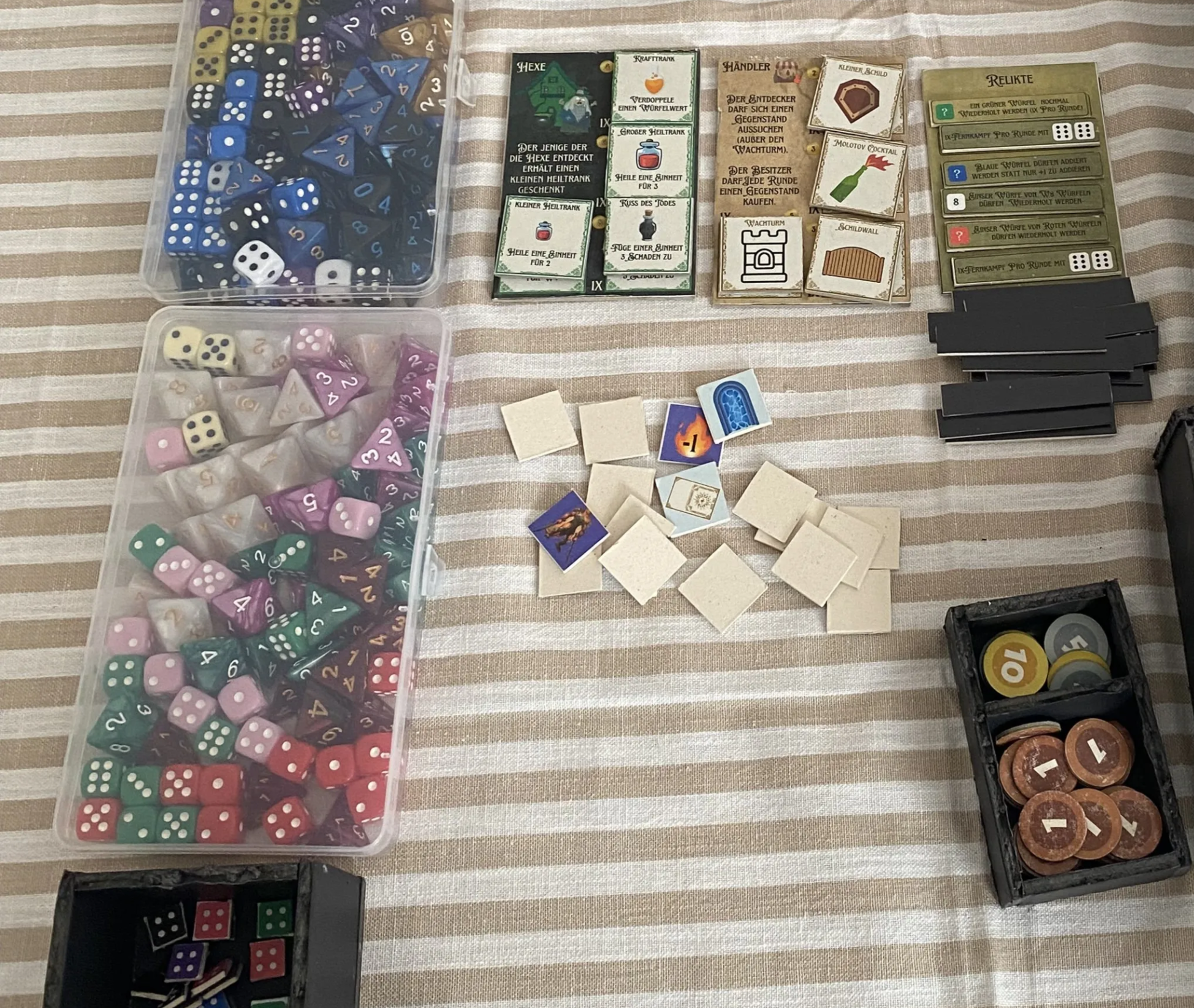 Board game prototype components including dice, dice runes, shops, relics, gold box and fog tiles
